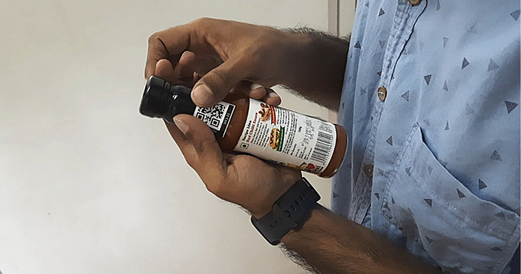 user gluing a Spacefelt tag on a sauce bottle